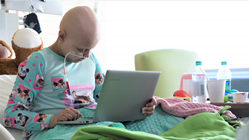 Pediatric cancer patient with Mikey's Way gift of a brand new laptop computer