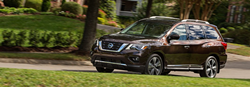 2019 Nissan Pathfinder driving down a rural road