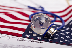 Image of stethoscope on U.S. flag and medical record; representing medical costs in the United States.