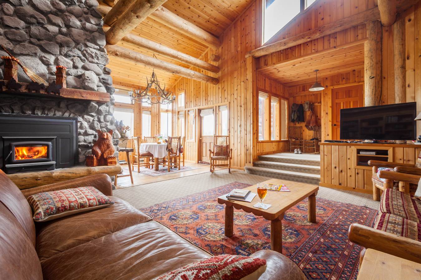 The cabin suite at Brooks Lake Lodge near Dubois, Wyoming, includes a comfy sitting area, fireplace, sofa-bed and private bedroom with king-sized lodgepole pine bed.