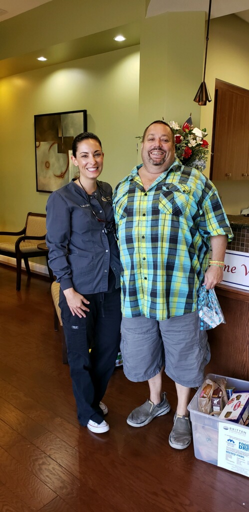 Dental hygienist volunteer Larisa, with patient M.B. who is a new patient to the event.