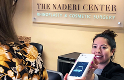 Naderi Center front desk staff assisting a patient with the payment process