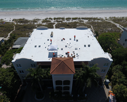 MaintenX Roofing Division technicians enjoy beachfront views while repairing a roof outside of Tampa, Fla.