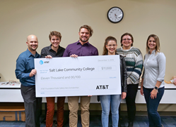 Students receive check for AT&T scholarship funds.