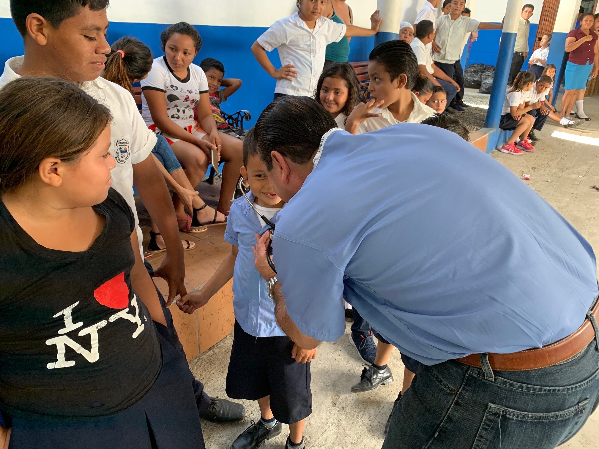 Carlos Araujo delivers medical treatment to one of the children in El Salvador