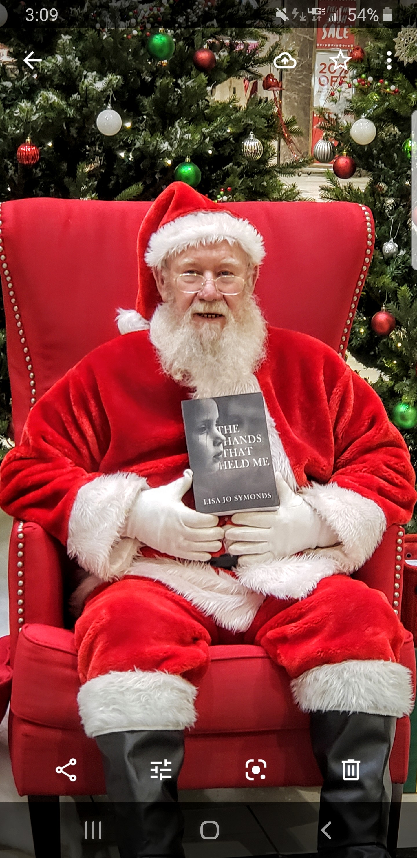 Santa holding your copy of "The Hands That Held Me"!