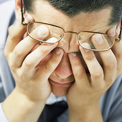 Man holding his head in his hands.