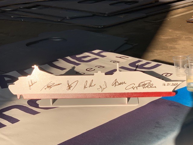 A traditional gift from the shipyard to the cruise line – a piece of steel cut in the profile of the expanded ship, signed by project managers.