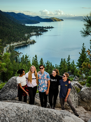 5 students from Sierra Nevada University pose for a snapshot above Lake Tahoe on the Tahoe Rim Trail.