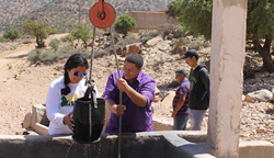WPI students check a greywater recycling system, part of a fog harvesting initiative in Morocco.