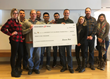 Staff from Swanson Rink present check to CU
