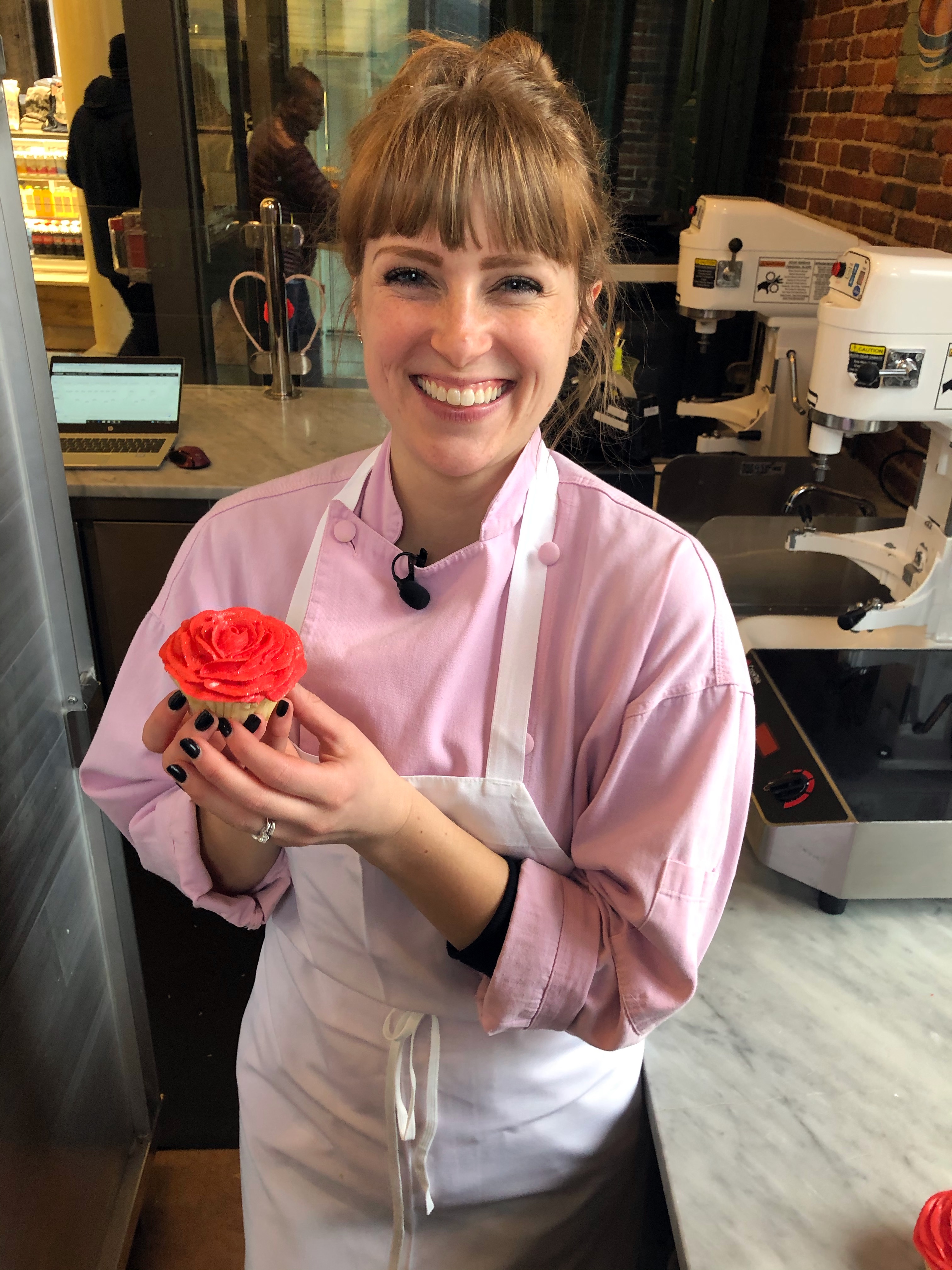 Sarah Wallace, Magnolia Bakery’s General Manager and competitor on Food Network’s Holiday Baking Championship, with a finished Valentine's cupcake