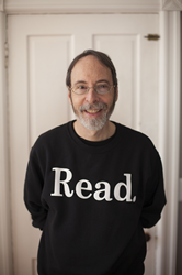 Photo of Author, Dan Gutman with a shirt that has the word READ.