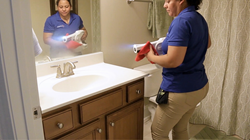 Maid Brigade Team Member Disinfecting a home with PUREmist