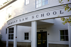 Oakes Hall at Vermont Law School, a white building with the school's name on it.