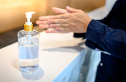 A person using hand sanitizer.