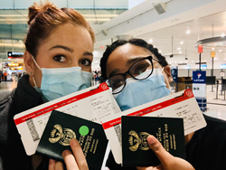 South African Travelers holding passport and boarding passes