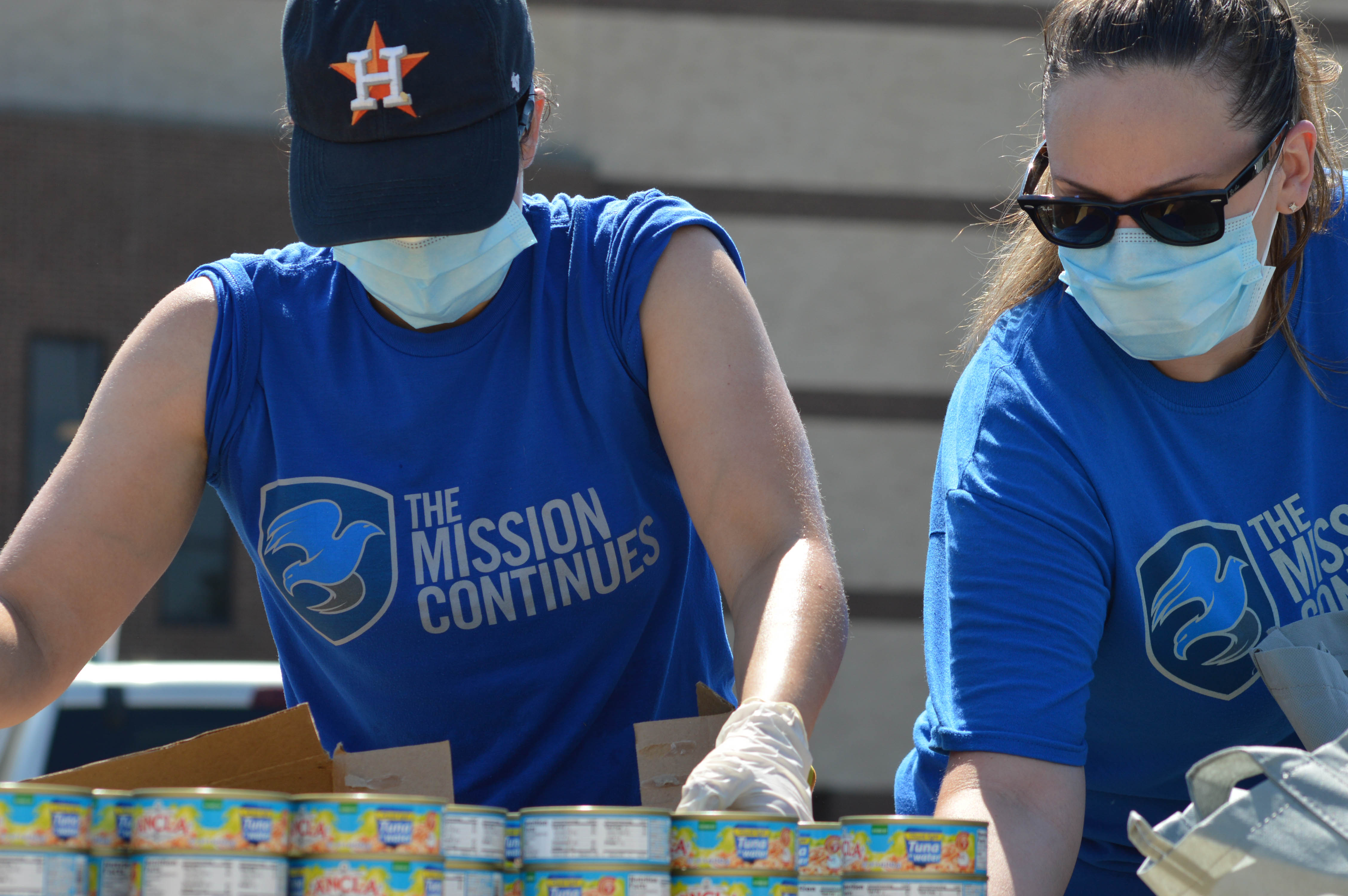 Volunteers sort through cans at food drive event