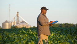 Farmer holding a tablet in a field