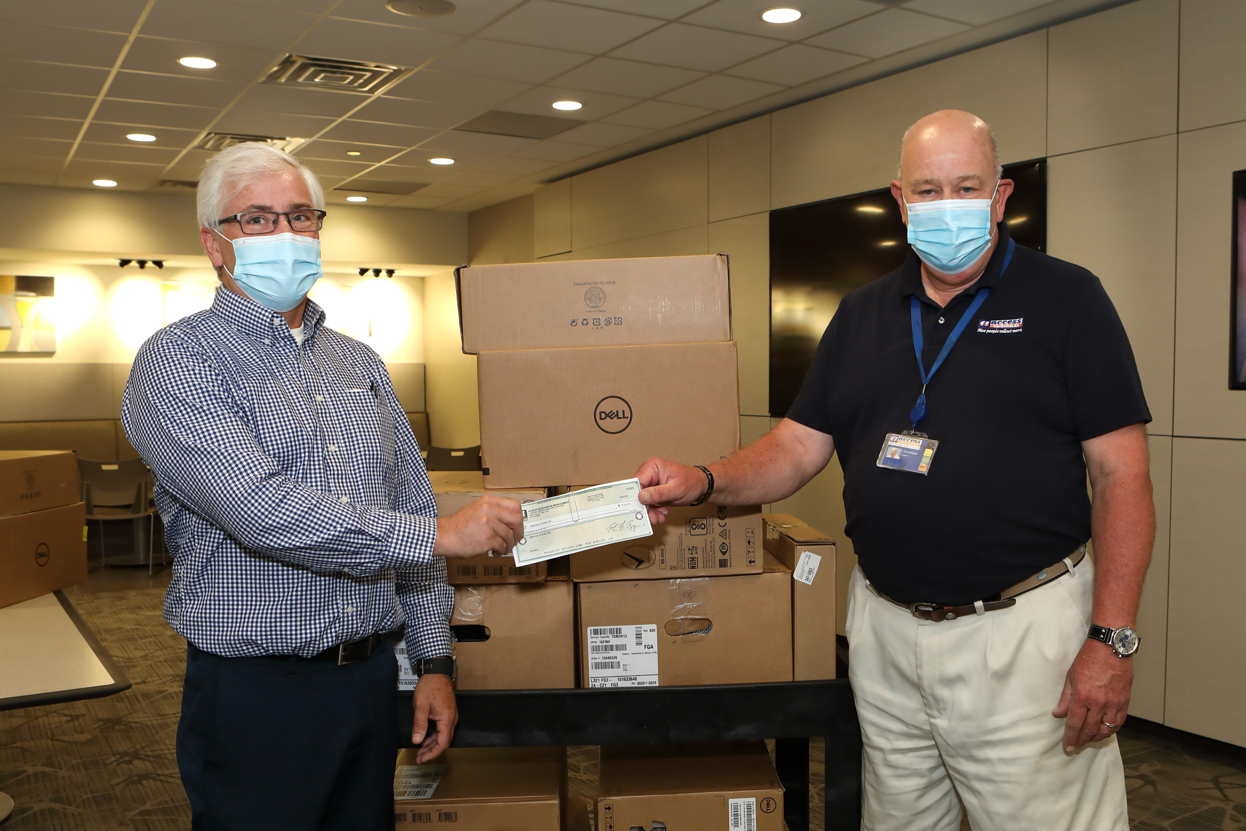 Ed Mullin, co-founder of DigiBmore receives donation from Tom Gillespie, president of Access Receivables Management