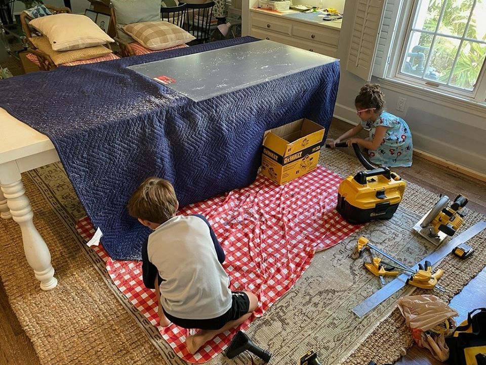 Dr. Britten designed and fabricated the acrylic barriers for his office at home to custom fit his front desk area. Here his children help clean up.