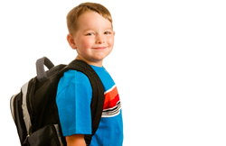A little boy with a backpack on smiling