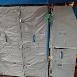 Reusable insulation blanket covering a boiler at a hospital.