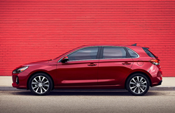 A red 2020 Hyundai Elantra GT parked against a red wall.