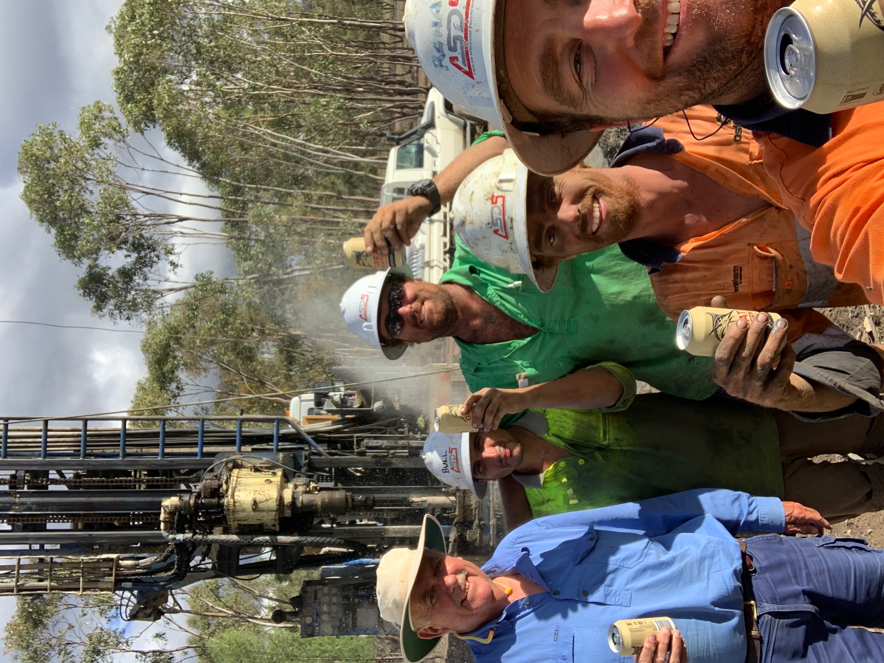 Farmer Angus Ferrier and drilling crew celebrate finding deep-seated water