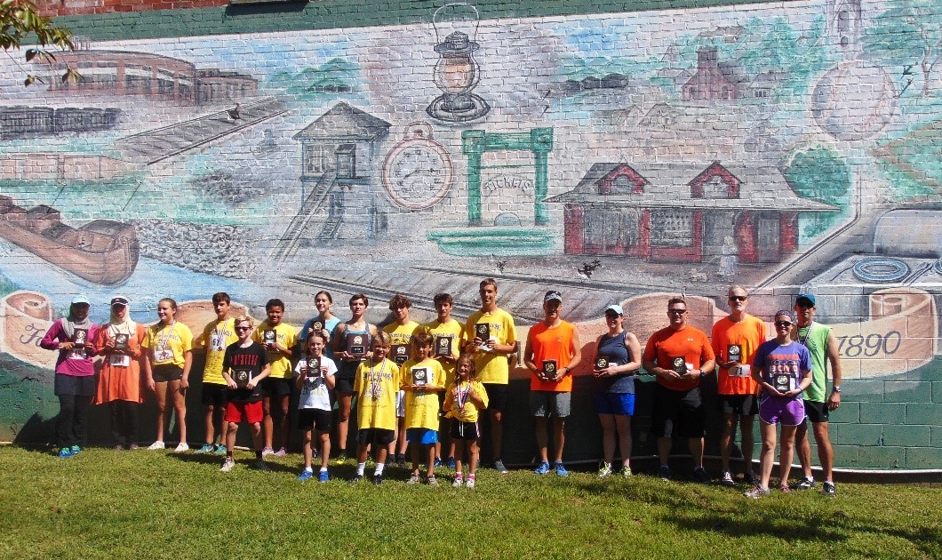 All 2018 Potomac Street Mile Winners in front of the Brunswick mural, Square Corner Park