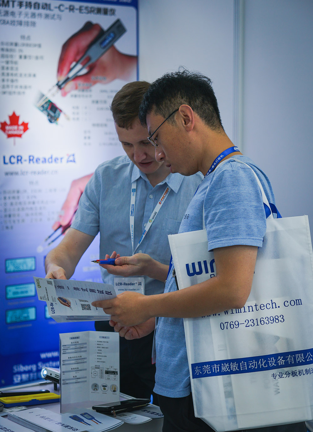 A visitor gets a demonstration of the LCR-Reader-MPA at Nepcon Asia