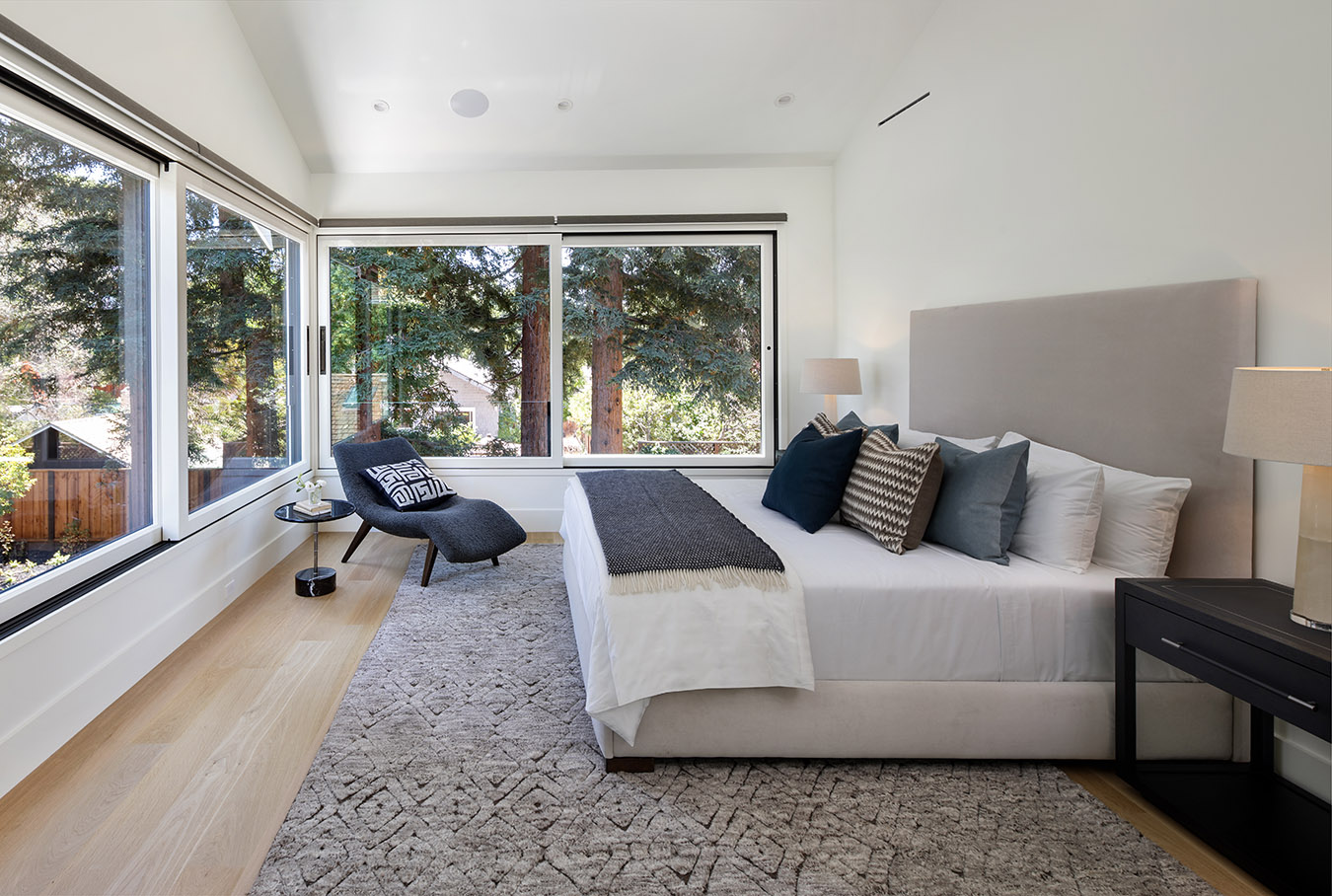 Enjoy the canopy of the majestic redwood trees as you retreat to the primary suite with its vaulted ceilings, oversized picture windows, spa-like bath, and spacious walk-in closet.