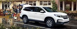 2021 Honda Pilot EX-L in platinum white pearl man putting groceries into back