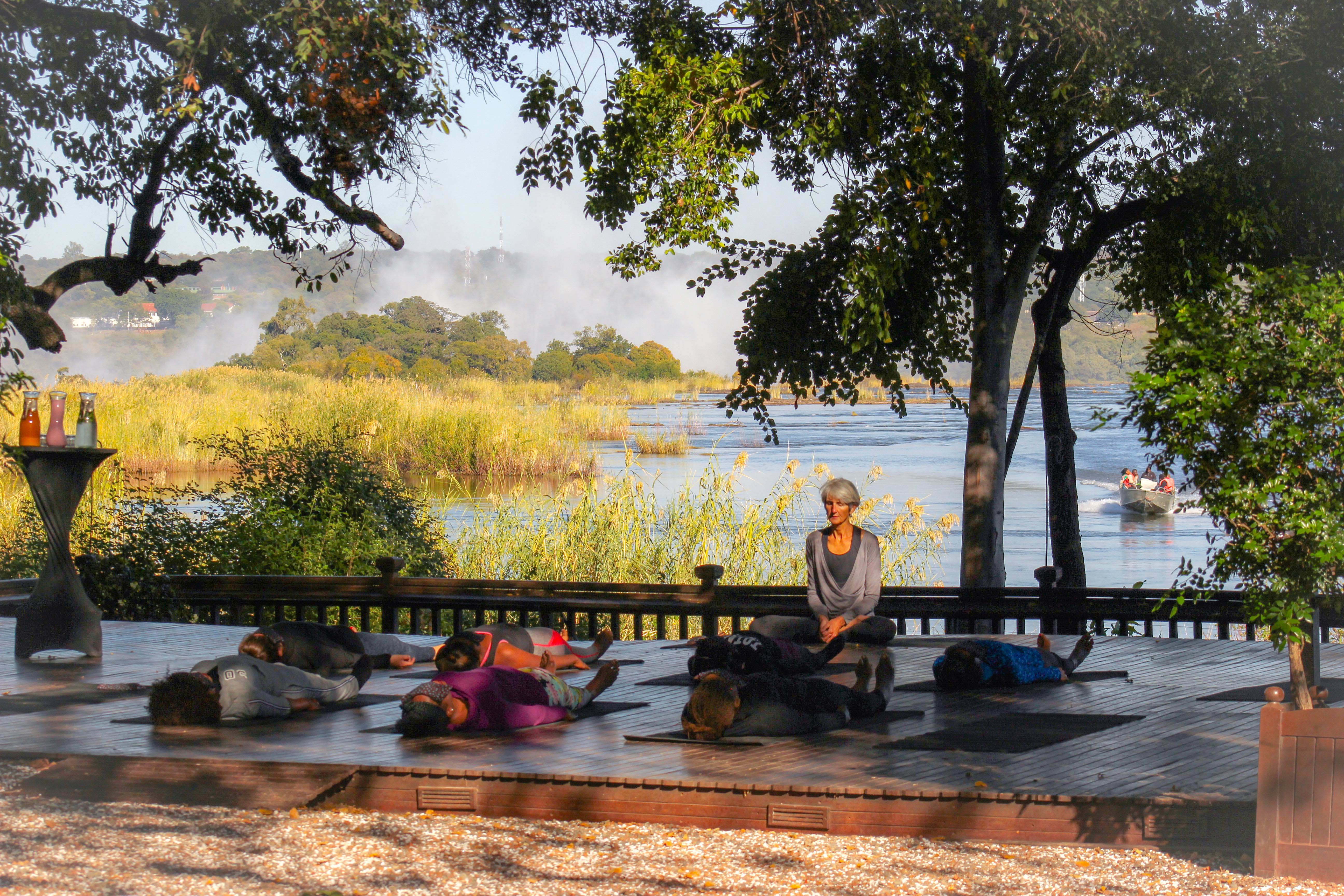 Sundeck yoga on the Zambezi River at The Royal Livingstone Victoria Falls Zambia Hotel by Anantara