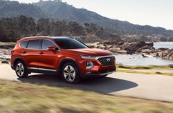 2019 Hyundai Santa Fe red driving along rocky shoreline