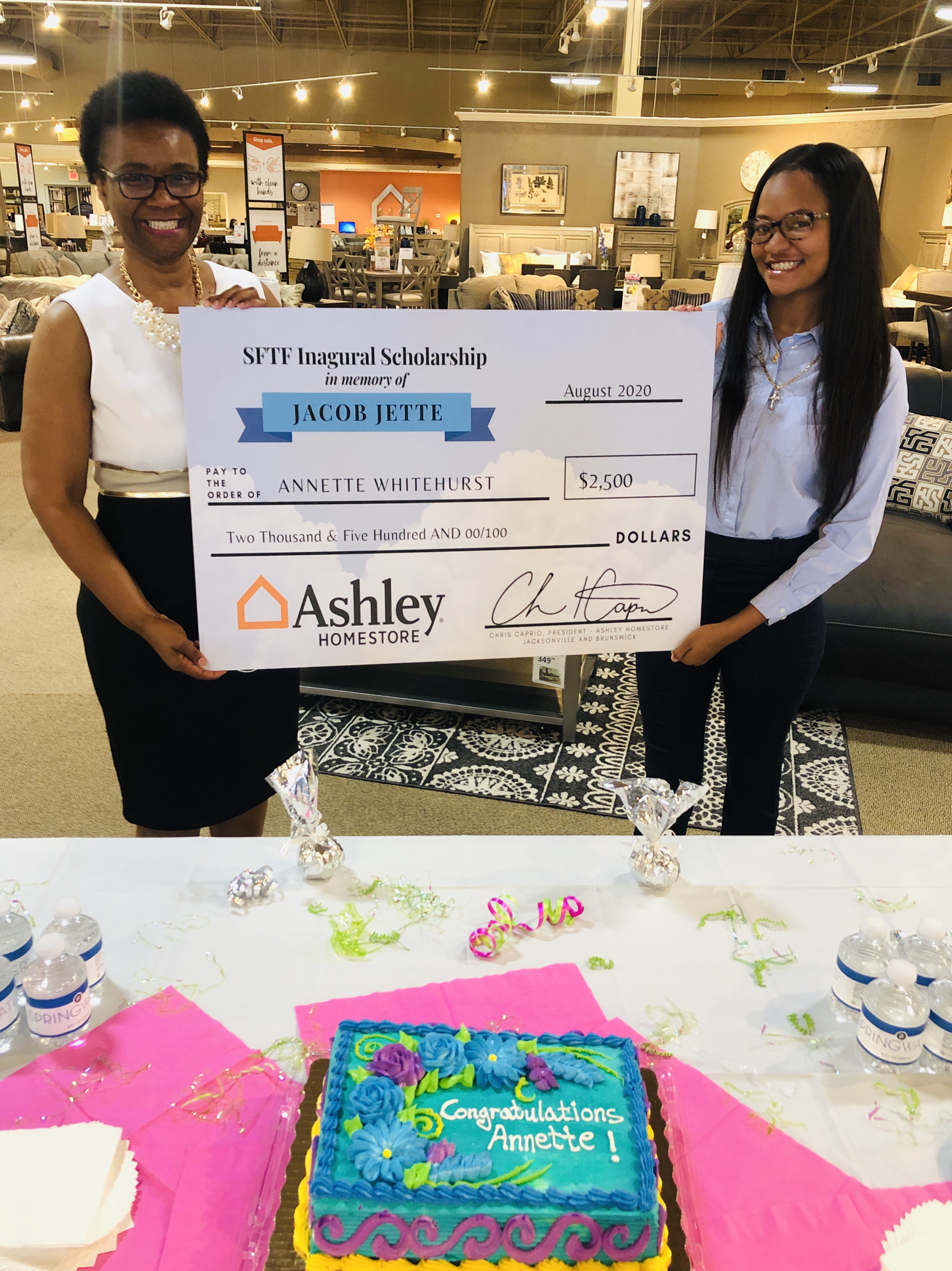 Ashley HomeStore Retail Sales Associate, Anita Whitehurst, and her daughter, Annette, accepted the scholarship award during a celebration at the St. Johns Town Center Ashley HomeStore location.