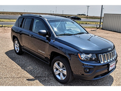 The front and side image of a dark blue 2015 Jeep Compass Latitude model available at Matador Motors.