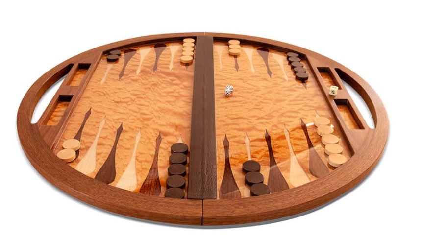 A rounded wooden backgammon table by Brian Boggs is just one example of the handmade work available for purchase with the Western Design Conference 2020 Digital Sourcebook.