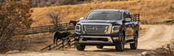 2021 Nissan Titan blue front view on a ranch