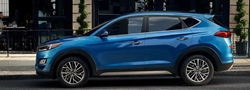 2021 Hyundai Tucson exterior driver side profile in front of cafe