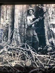 Robert Charles Scheckler with Machine Gun in the jungles of New Guinea