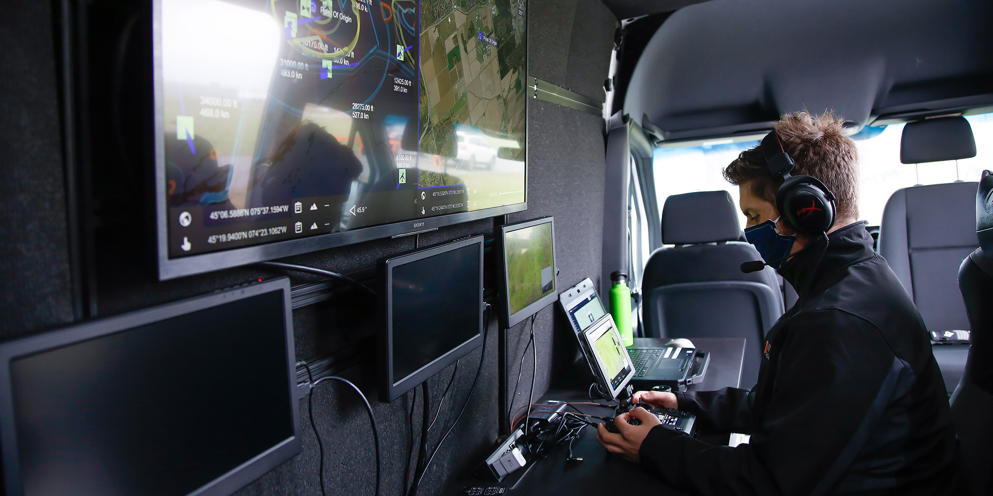 An operator pilots a drone from inside the Area X.O mobile command center. The Mobile Command Center will be touring Canada to demonstrate technology for integrating drones into emergency operations.