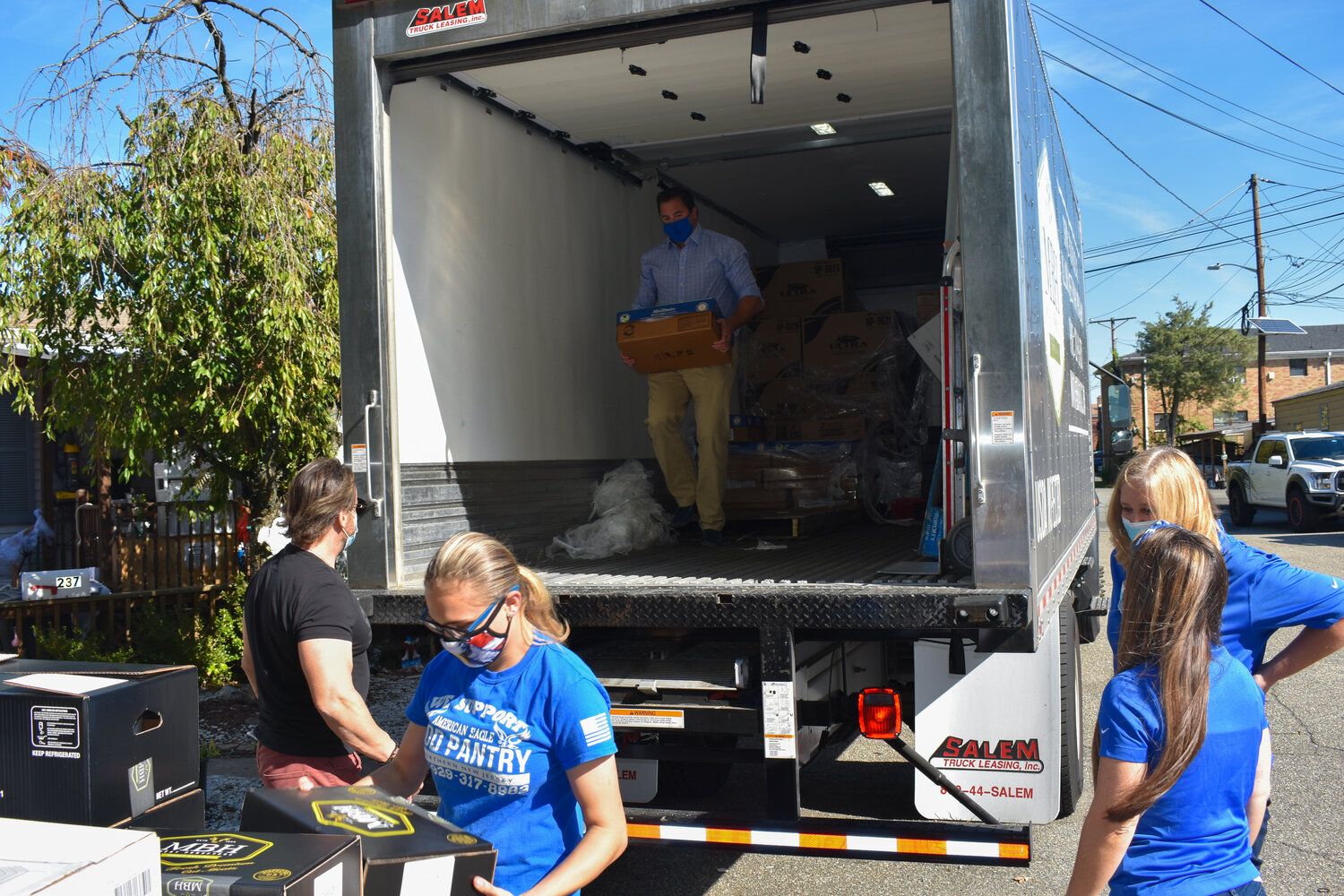 Bertone Piccini LLP Founding Partner, Jeremy S. Piccini, helps unload eight pallets worth food for American Eagle Food Pantry.