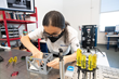 Jana Alaslani works at the optical table to assemble test components into a 3D-printed prototype of the EagleCam CubeSat camera system. (Photo: Embry-Riddle/David Massey)