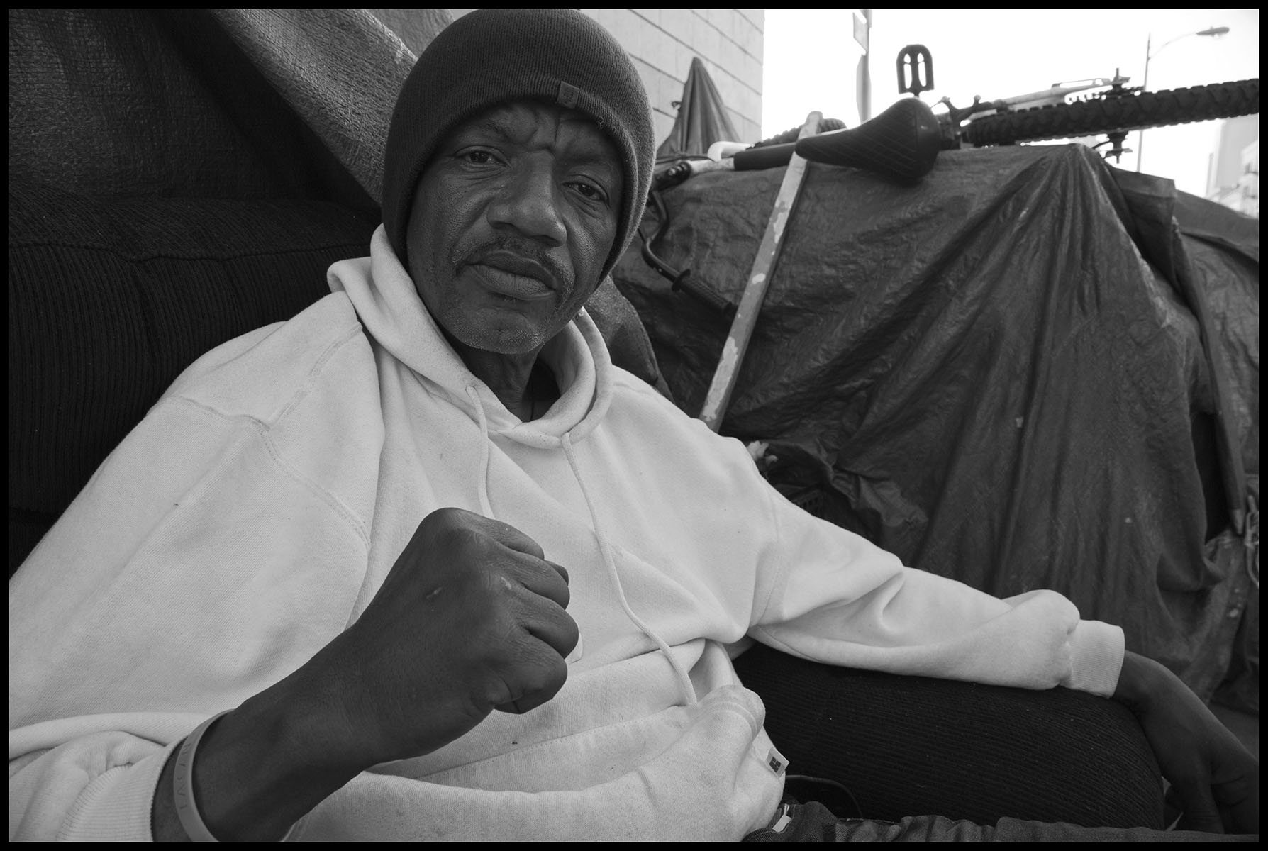 General TC calls himself "The Peoples' General and lives on the sidewalk on Skid Row. 2014, Los Angeles. The David Bacon Archive, Department of Special Collections, Stanford Libraries.