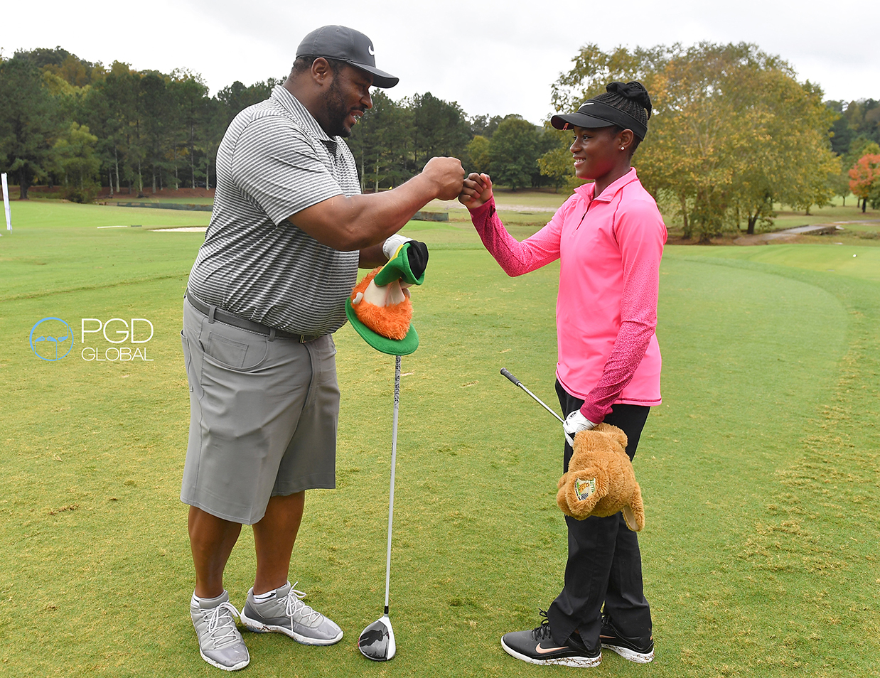 Jerome Bettis, NFL Hall of Fame and Ariel Collins, US Kids World Champion fist bump on the first tee after being granted the 2020 Calvin Peete Award recipients.