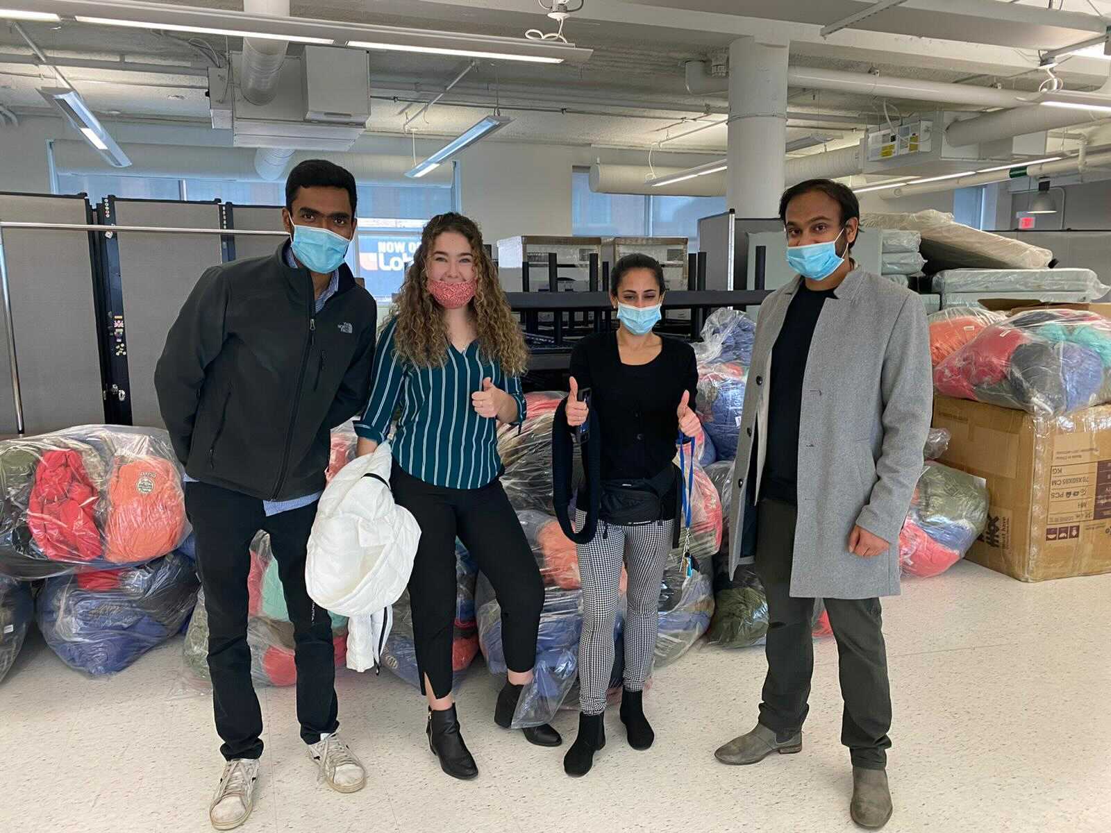 Nirav Gandhi and his team at Homes First Society with 700 jackets for donation.