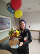 Jennifer A. holding flowers and balloons