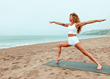 Yoga teacher, Jess Ray on the Root Board on the Santa Monica beach