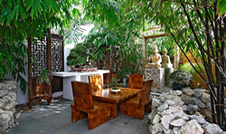 Serenity reigns in the meditation corner with an Indonesian Buddha altar and a teak table and chairs handmade in Bali.